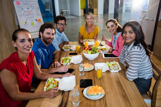 istock Casual business team eating together 664848470