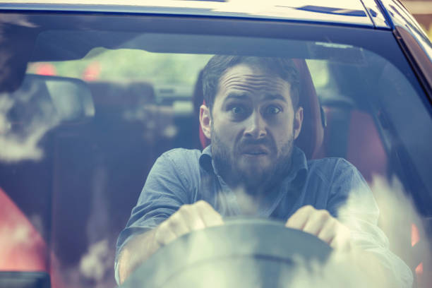 Stressed scared young man driver. Inexperienced anxious motorist concept