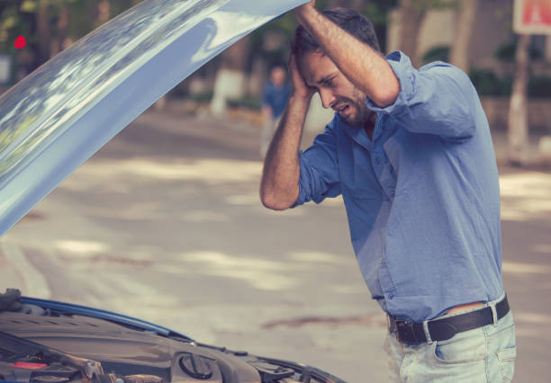 istock young stressed man driver having trouble with his broken car looking in frustration at failed engine 664857822