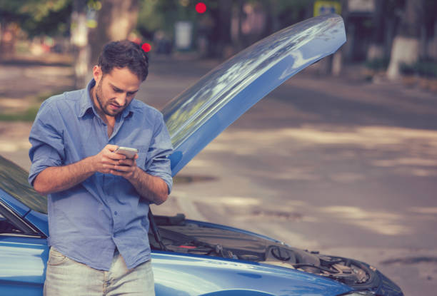 istock young stressed man driver having trouble with his broken car looking in frustration at failed engine 664857828