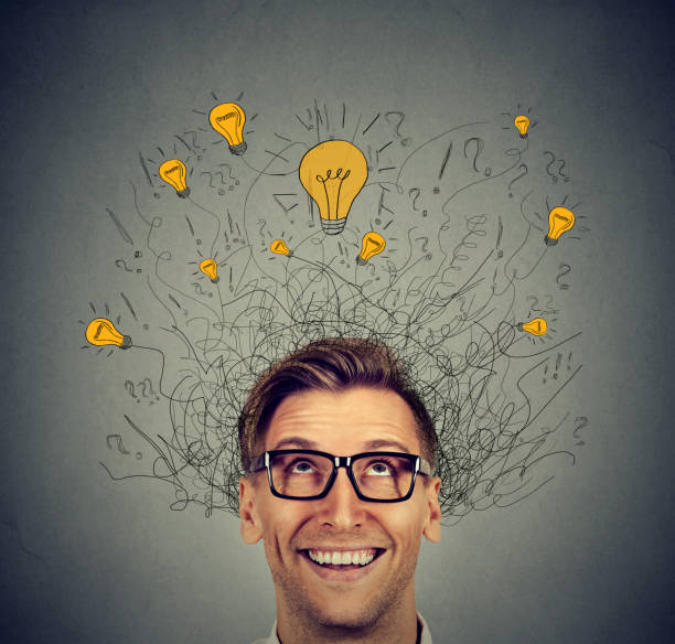 istock Excited man with many ideas light bulbs above head looking up 664860536