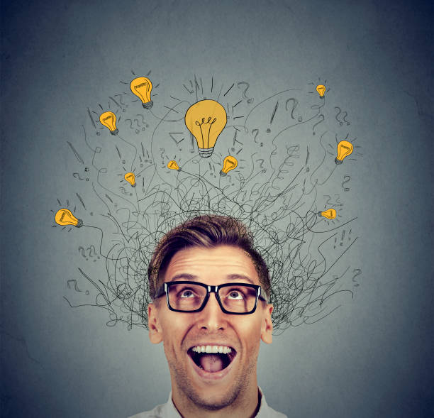 istock Excited man with many ideas light bulbs above head looking up 664860542