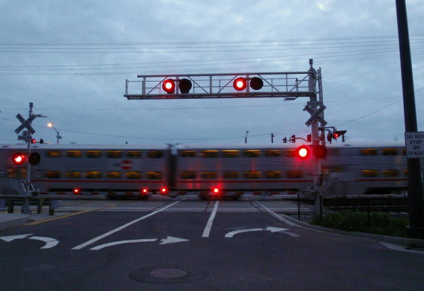 istock Train races by rail crossing at dusk 664867612