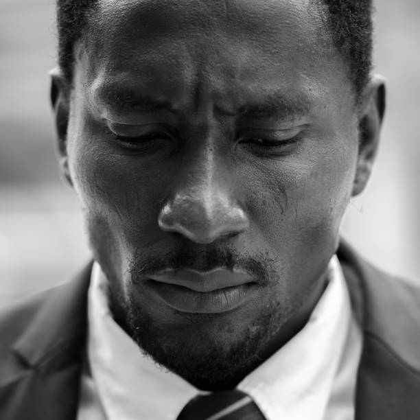 istock Face of sad young African businessman thinking while looking down 664871214
