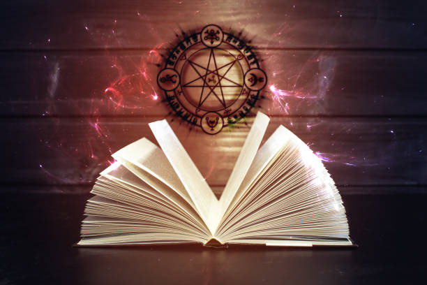 istock Book on the table out comes light and magic sign 664874568
