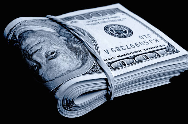 istock A stack of hundred-dollar bills folded in black and white. 664875184