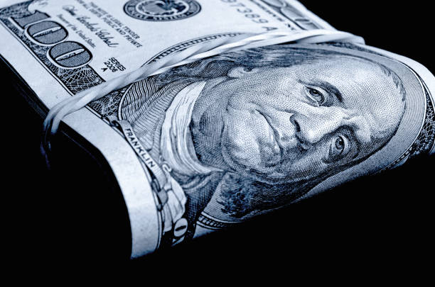 istock A stack of hundred-dollar bills folded in black and white. 664875204