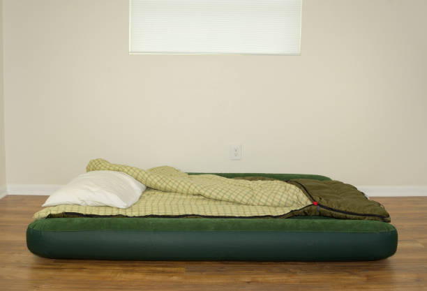istock Blow up air mattress bed with sleeping bag and pillow 664877570
