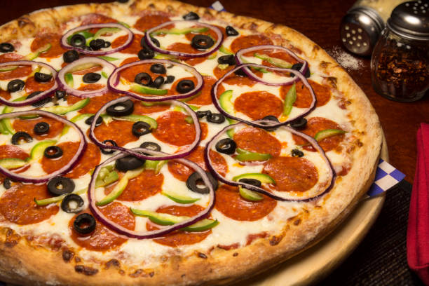 istock Italian Pizza Pie With Pepperoni Onion Black Olives 664878288