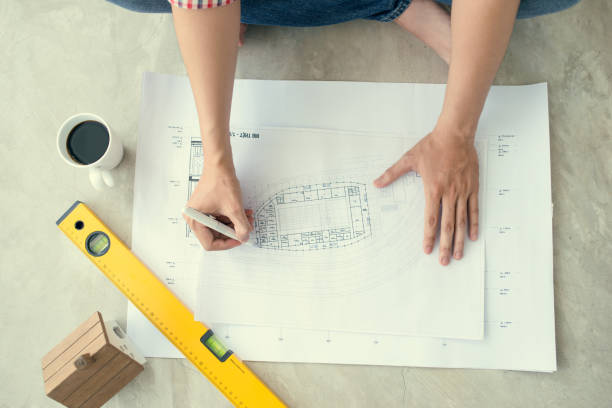 istock asian architect working at home on the floor. 664878478