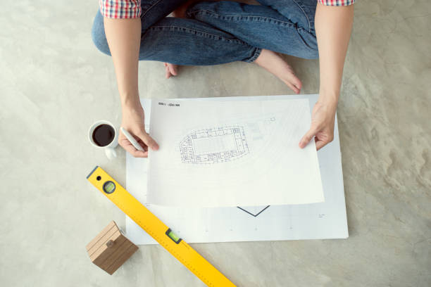 istock asian architect working at home on the floor 664878590