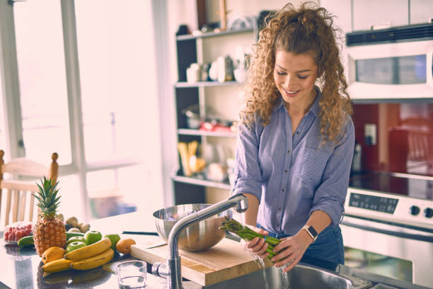istock Young beautiful woman cooking while working from home 664878608