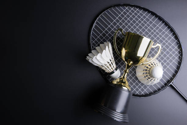istock Golden trophy, Shuttlecocks and badminton racket on black background.Sport concept, Concept winner, Copy space image for your text. 664878708