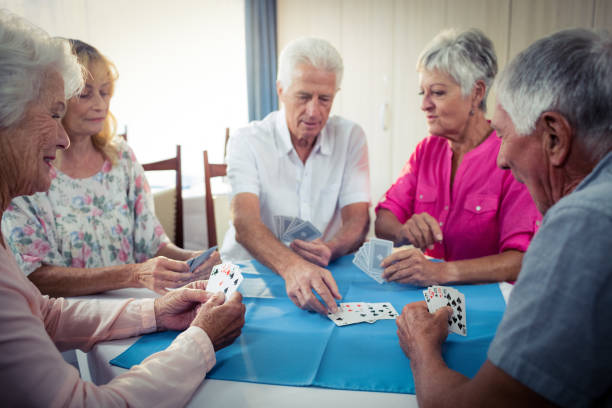 istock Group of seniors playing cards 664888780