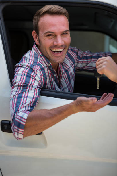 istock Young man receiving car keys 664889064