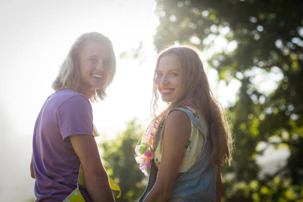istock Young couple smiling in park 664889824