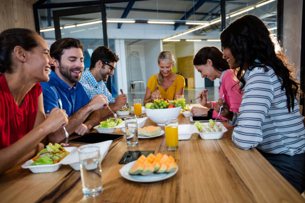 istock Casual business team eating together 664890392