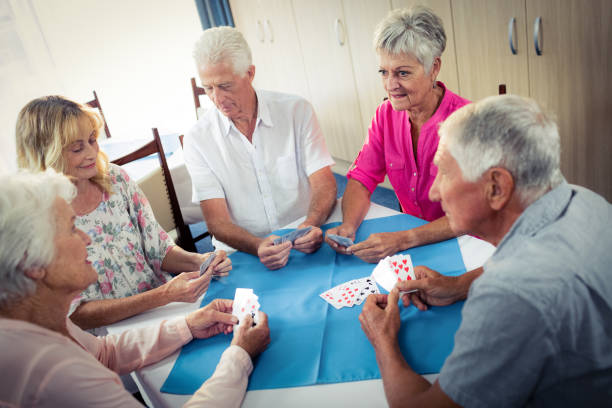 istock Group of seniors playing cards 664890464