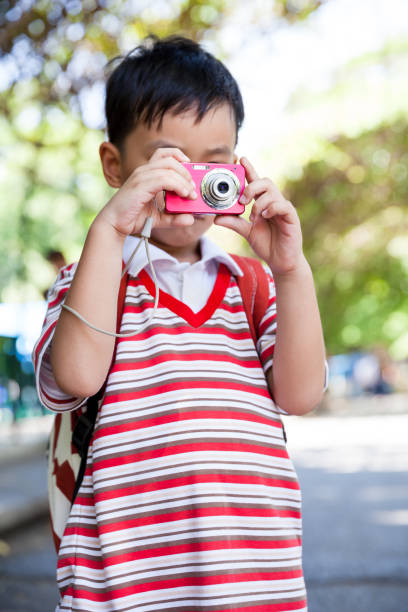 istock Boy taking photo, on blurred nature background. Active lifestyle. 664899414
