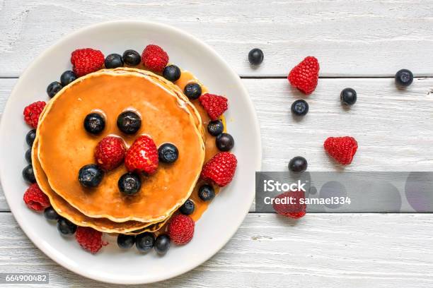 Stack Of Pancakes With Fresh Berries And Caramel Sauce Stock Photo - Download Image Now