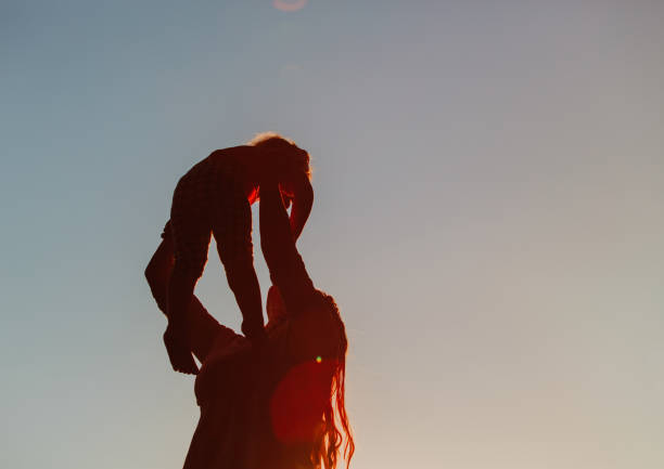 istock mother and little daughter play at sunset 664907400