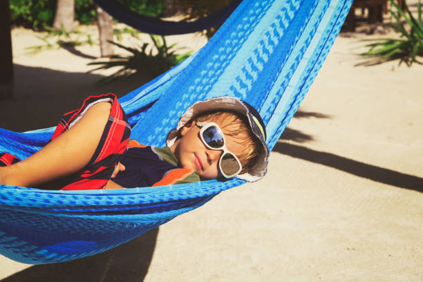 istock happy little boy relaxed in hammock on beach 664908926