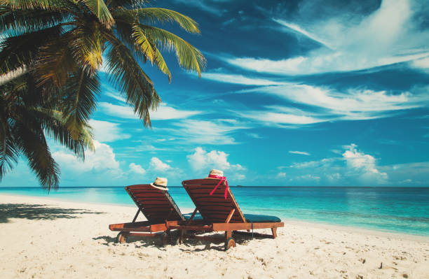 istock Two chairs on the tropical beach 664909234
