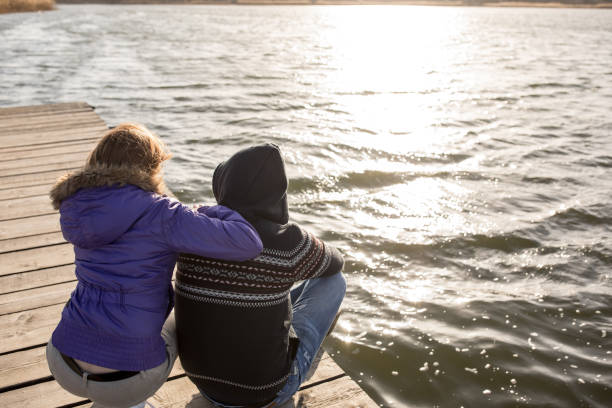 istock couple enjoying on lake pier 664916294