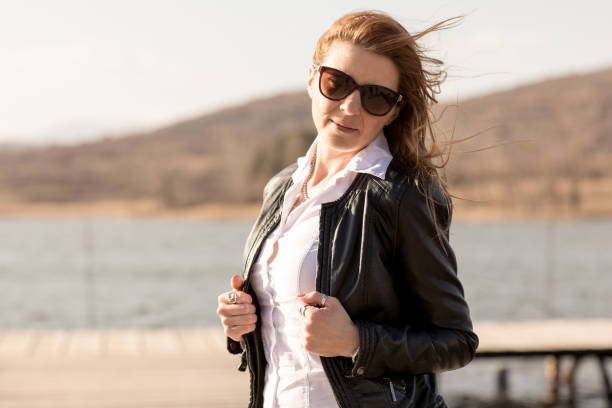 istock Young woman on lake pier 664916744