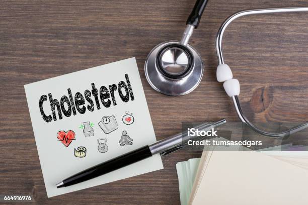 Cholesterol Workplace Of A Doctor Stethoscope On Wooden Desk Background Stock Photo - Download Image Now