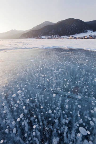 istock Bubbles in ice. Baikal lake. Winter landscape 664923276