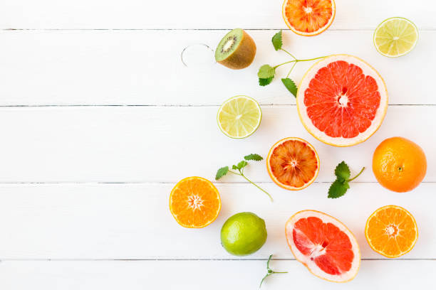 istock Colorful fresh fruit on white table. Flat lay, top  view 664928144