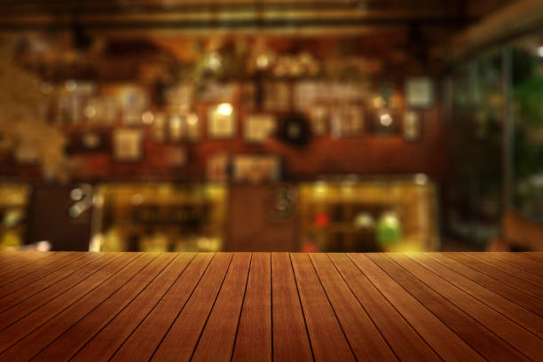 istock blur cafe background with wooden table in foreground 664928470