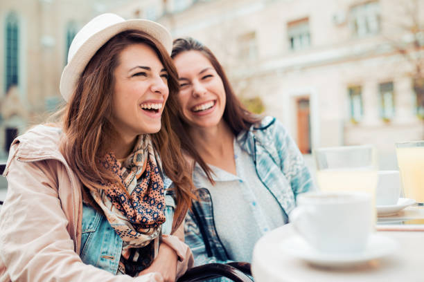 istock Two beautiful young girls sitting in a cafe 664931118