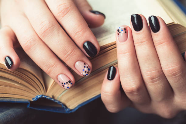 istock Young woman reading book, close-up, on home interior 664931400
