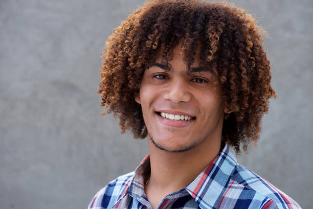 istock cool guy with curly hair smiling 664934054