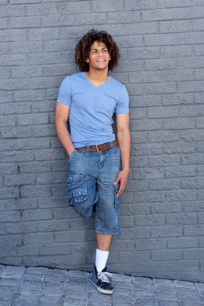 istock Full body cool young guy with curly hair smiling 664934134