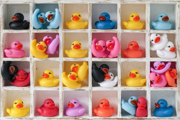 istock Many multi-colored rubber ducks in pigeon hole compartments alone as couples and in groups. 664934548