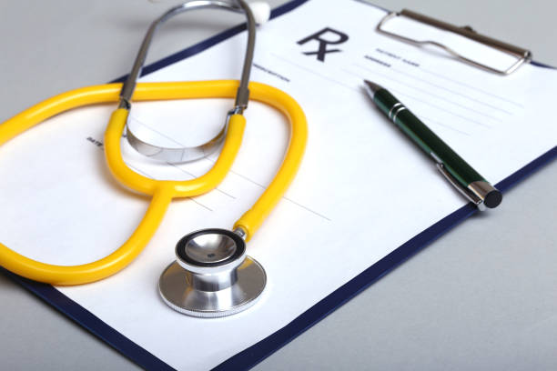 istock RX prescription and a stethoscope on white background 664934650
