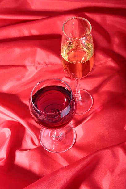 istock Two Glass of red, white wine on red background 664935030