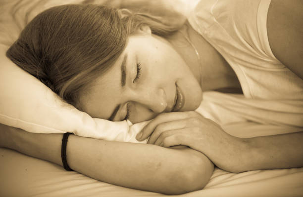 istock Young female lying with closed eyes in bed 664938146