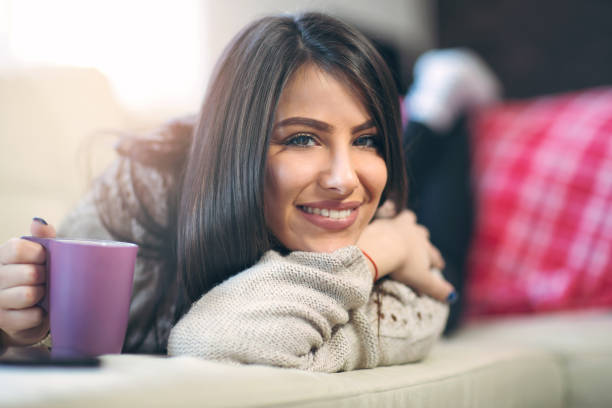 istock Woman relaxing at home and drinking coffee 664940078