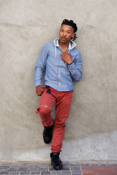 istock Full length cool african man with dreadlocks leaning against wall 664940278