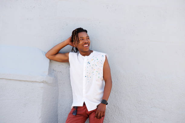 istock cool african guy leaning against gray wall 664940344
