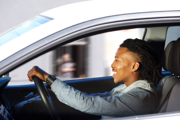 istock happy young black man driving car 664940442