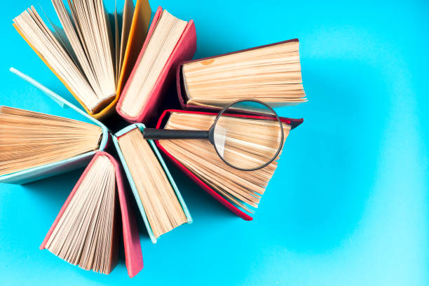 istock Top view of bright colorful hardback books in a circle. 664942724