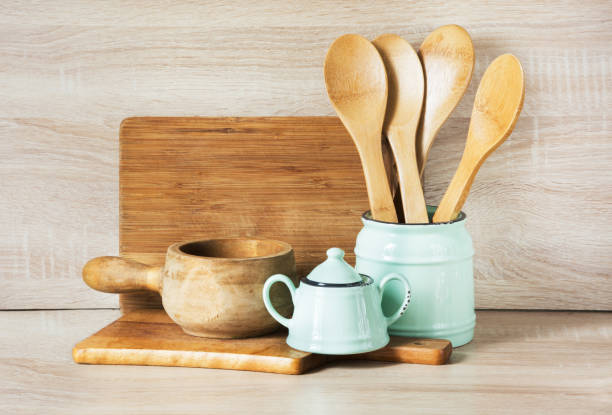istock Turquoise and wooden vintage crockery, tableware, dishware utensils and stuff on wooden table-top. Kitchen still life as background for design. Image with copy space. 664942914