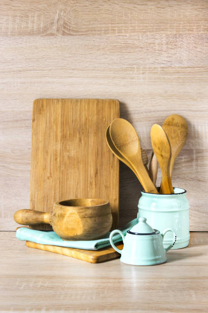 istock Turquoise and wooden vintage crockery, tableware, dishware utensils and stuff on wooden table-top. Kitchen still life as background for design. Image with copy space. 664942920