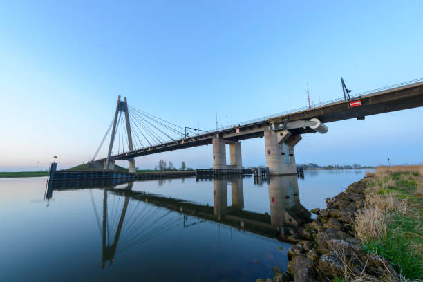 istock Eilandbrug suspension bridge over river IJssel in Overijssel, Netherlands 664943116