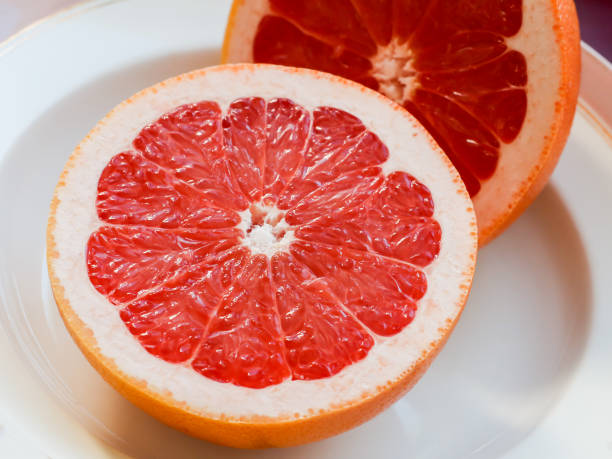 istock Half of a pink grapefruit on the plate 664943300